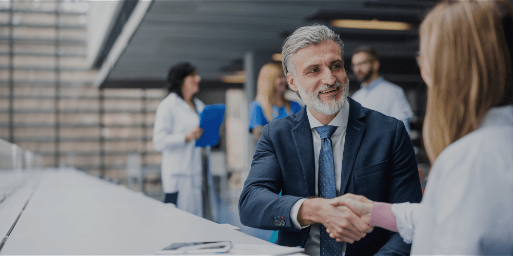Two business leaders shaking hands after reaching an agreement